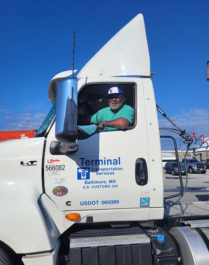 truck driver for terminal transportaion sitting in truck cab